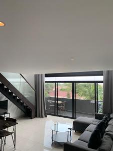 a living room with a couch and a table at One Bedroom Premium Luxury Apartments at The Embassy Garderns in Cantonments +2 photos