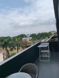 a balcony with a table and chairs on a building at One Bedroom Premium Luxury Apartments at The Embassy Garderns in Cantonments