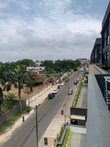 a city street with cars parked on the road at One Bedroom Premium Luxury Apartments at The Embassy Garderns in Cantonments
