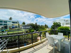 a balcony with a table and chairs and a view at The nice condo 2 BR at Karon in Karon Beach