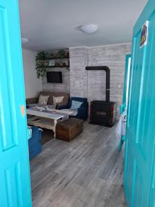 a living room with a couch and a table at Šumarac in Karadak