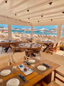 a restaurant on the beach with tables and chairs at THALASSA BOUTIQUE HOTEL in Sarti