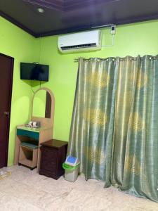 a room with a shower curtain and a sink at Sascha's Resort Oslob in Oslob