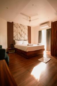 a bedroom with a large bed and a wooden floor at Lume Stayz in Siolim
