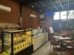 a restaurant with a counter with bottles of wine at Hamsun Shahrah-e-Faisal in Karachi