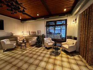 a living room with couches and chairs and a window at Brauhaus am See in Oberthulba