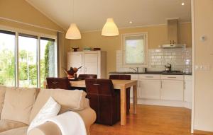 a kitchen and living room with a couch and a table at Seehund 102 in Sint Annaland