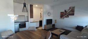a living room with a couch and a table at Sunshine III Apartment in Kragujevac