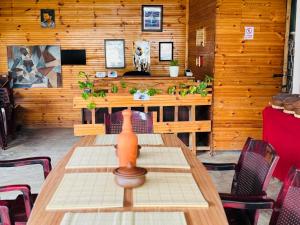 a wooden room with a table and chairs in it at Ratnam Hotel Jaffna in Jaffna +52 photos