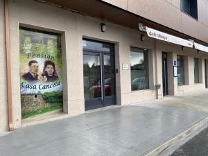 a building with an advertisement on the side of it at Pensión Casa Cancela in Palas de Rei