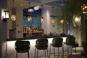 a bar with chairs and a counter with drinks at EVEN Hotel Shenzhen Nanshan by IHG in Shenzhen