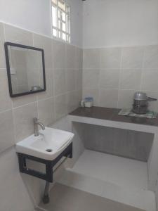a bathroom with a sink and a mirror at Sumud Bonda Homestay in Kuala Kerai