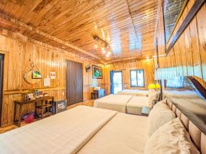 a bedroom with two beds and a wooden ceiling at Hang Lan Ecolodge in Ninh Binh +65 photos