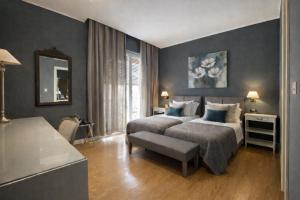 a bedroom with two beds and a table and a mirror at Maxim in Palermo