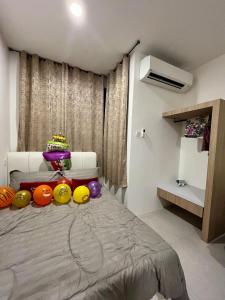 a bedroom with a bed with a cake on it at Studio at dMillenia Residences in Kota Samarahan