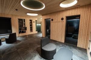 a room with chairs and a table and lights at Camping Olympia in Dobbiaco