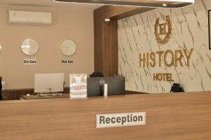 a reception desk in an office with a houstonury hotel sign at History Hotel in Dirē Dawa