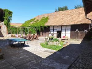 a patio with a table and chairs in front of a building at Pension Hoffmann in Trebra