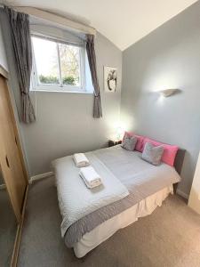a bedroom with a large bed with a window at Cosy County House apartment with free private parking Sleeps up to four guests in York