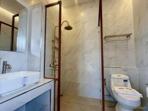 a bathroom with a toilet and a sink and a shower at มนต์จันทรา เฮ้าส์ in Khlong Lan +83 photos