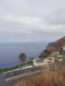 a view of the ocean from a house at Farol views in Fajã da Ovelha