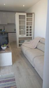 a living room with a bed and a kitchen at Farol views in Fajã da Ovelha