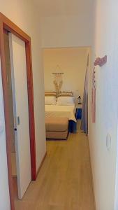 a bedroom with a bed in the middle of a room at Farol views in Fajã da Ovelha