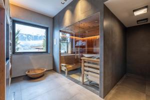 a bathroom with a large window and a sink at Seehotel Bellevue by keyone in Zell am See