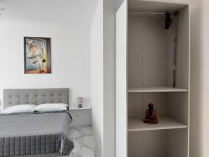 a bedroom with a bed and a book shelf at Apartments Marini in Pordenone