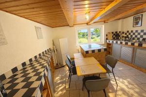 a kitchen with a table and chairs in a room at Apartment-schiefe- Marie in Oberlungwitz +6 photos