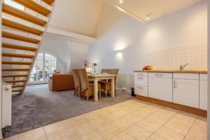 a kitchen and dining room with a table and chairs at Strandnest in Dierhagen