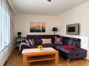 a living room with a couch and a table at Erholung im Westerwald ! in Hachenburg