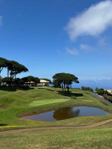 a view of a golf course with a pond at Casa das Flores Funchal in Funchal