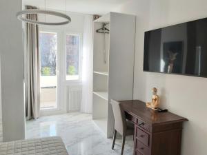 a room with a desk and a chair and a window at Apartments Marini in Pordenone