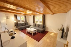 a living room with a couch and a table at Apartment-schiefe- Marie in Oberlungwitz