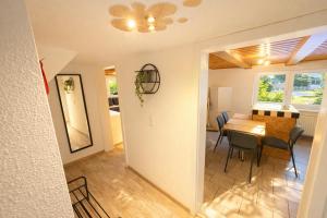 a dining room and living room with a table and chairs at Apartment-schiefe- Marie in Oberlungwitz