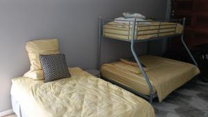 a room with two bunk beds and a bed at Casa Mia in Jeffreys Bay