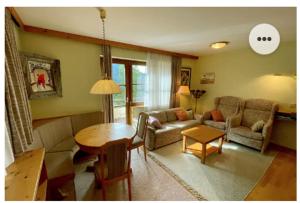 a living room with a couch and a table at The Mountain Home in Hermagor