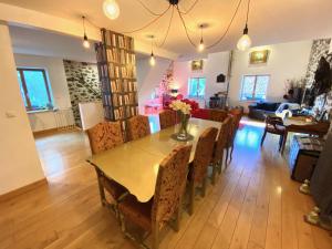 a dining room and living room with a table and chairs at La Grange Saillant Saint Nectaire in Saillant