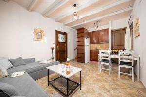 a living room with a couch and a table and a kitchen at Panorama II Villas in Lévktron
