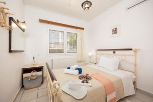 a bedroom with a bed with a tray of food on it at Villa Stephania in Gaios +23 photos
