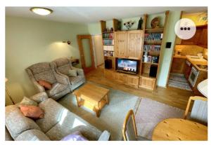 a living room with a couch and a table at The Mountain Home in Hermagor