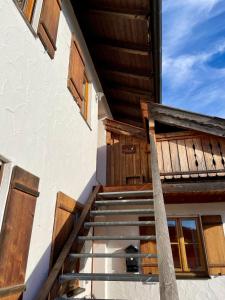 a stairway leading up to a building with wooden doors at Esingerhof in Laufen