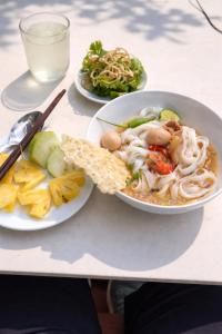 a table with two plates of food on it at Sea and Sand Hotel in Hoi An