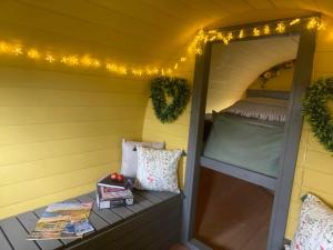 a tiny house with a bed and a window at Ty Grug Retreat in Little Newcastle +58 photos