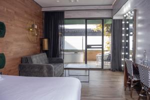 a hotel room with a bed and a living room at Garden Hotel Boutique & Events in Haifa +128 photos