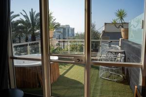 a view from the window of a balcony at Garden Hotel Boutique & Events in Haifa