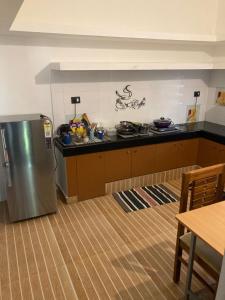 a kitchen with a stainless steel refrigerator in a room at The Golden, Apartrooms in Trivandrum