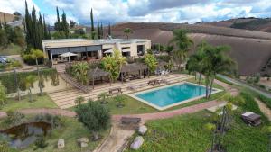 an aerial view of a house with a swimming pool at Lodge du Barrage in Rabat