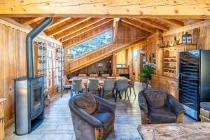 a large living room with a table and chairs at Chalet les trois coeurs in Méribel